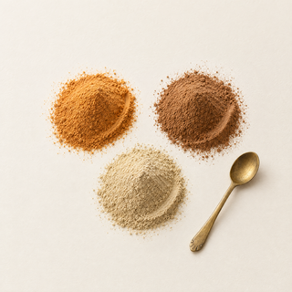 Mucuna, triphala and ashwagandha extract powders with a brass spoon