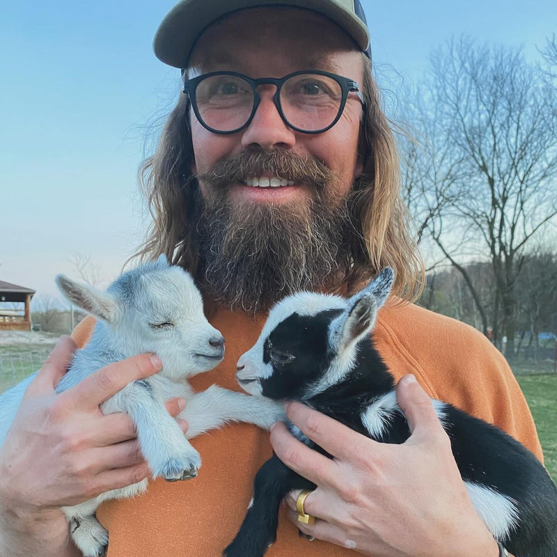 Scott Linde with two goat kids, 2025