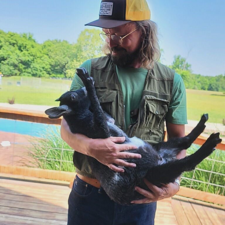 Scott Linde and a black goat kid, 2025