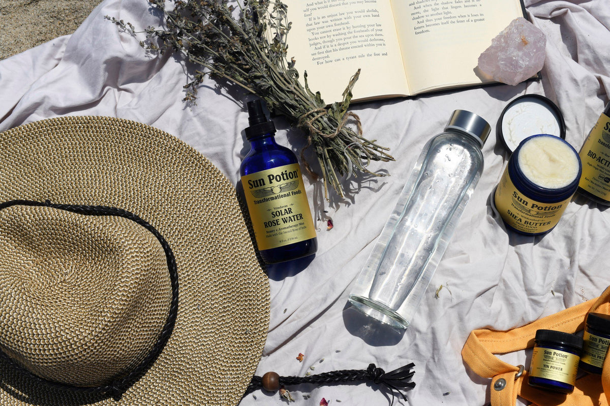 Sun Potion rose water and shea butter on a picnic blanket