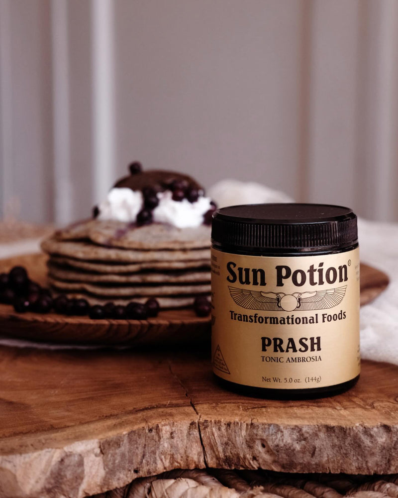 Jar of Sun Potion Prash beside a stack of pancakes