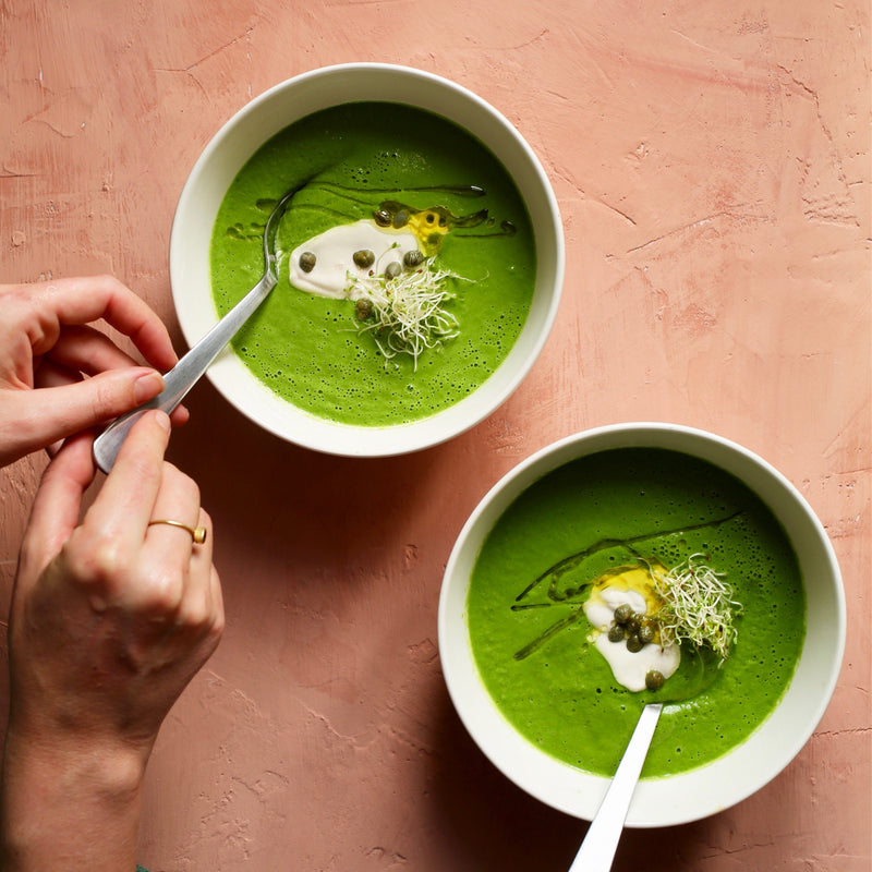 Two bowls of green soup