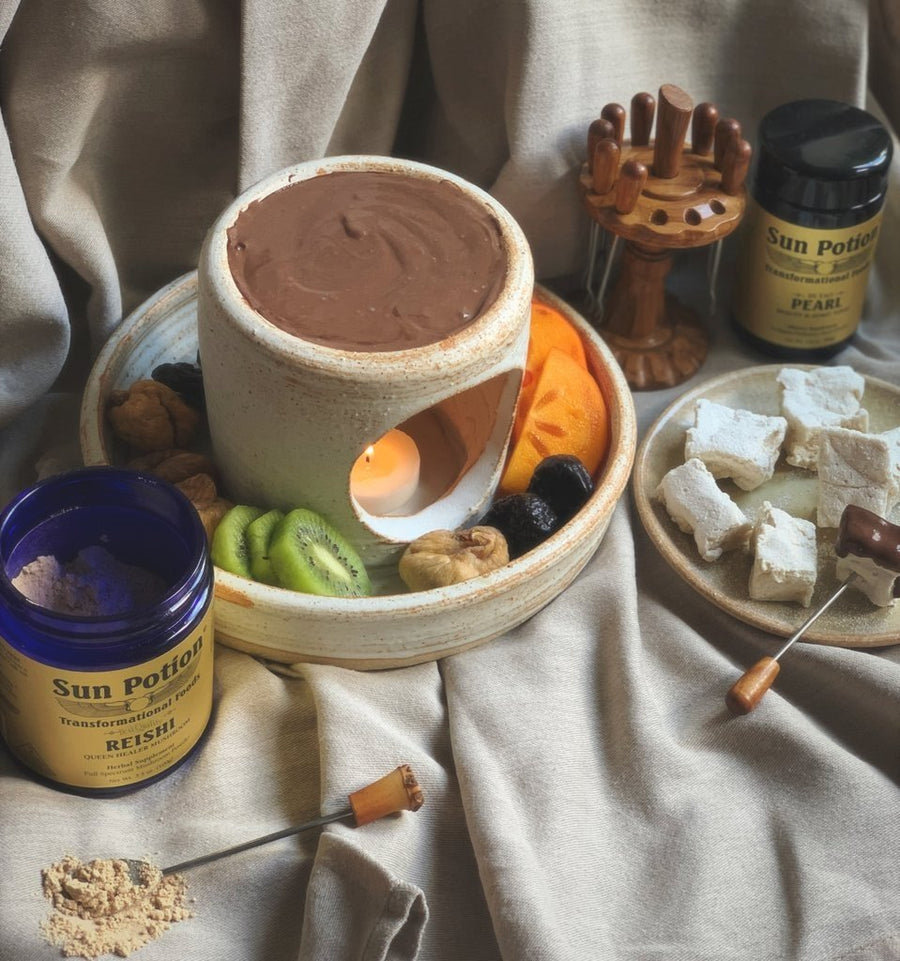 Jar of Sun Potion Reishi on a table set for chocolate fondue